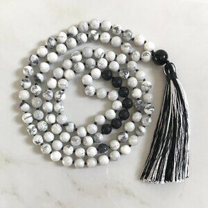 WHITE HOWLITE AND BLACK LAVA MALA WITH A BLACK AND WHITE TASSEL
